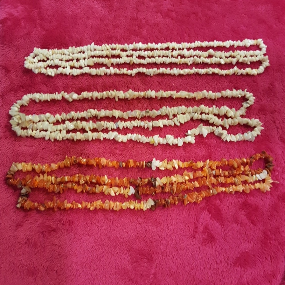 3 stands. 1 fire opal, 1 opal, and 1 coral.